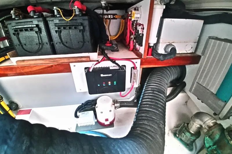 Slide: The Image of Engine room of 2008 Legacy Yachts 32, featuring batteries and electrical components. - 70