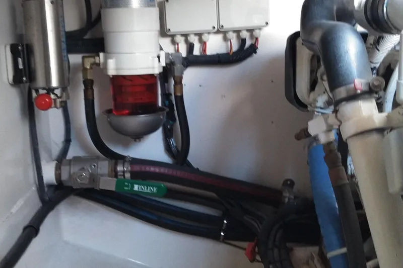 Slide: The Image of Engine room of a 2008 Legacy Yachts 32, showcasing mechanical components and piping. - 73