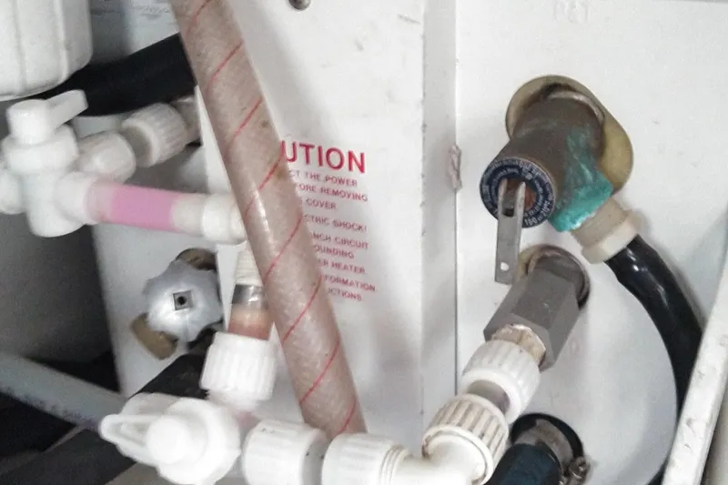 Slide: The Image of Engine compartment of 2008 Legacy Yachts 32, showing plumbing and electrical components. - 74