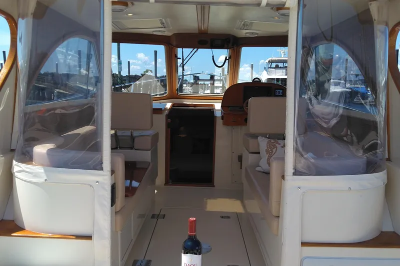 Slide: The Image of Interior view of 2008 Legacy Yachts 32, featuring seating and helm station. - 82