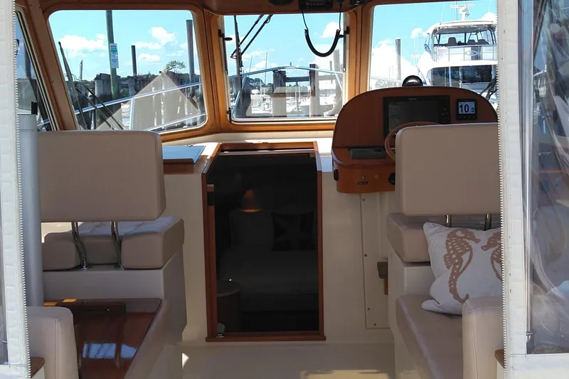 Slide: The Image of Interior view of 2008 Legacy Yachts 32, featuring helm and seating area. - 85