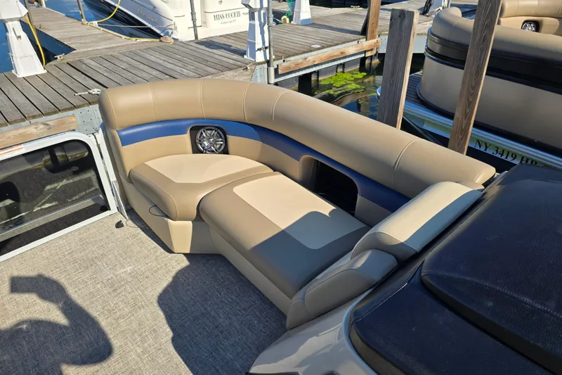 Slide: The Image of Luxurious seating on 2025 Premier 210 SunSation RE pontoon boat at dock. - 6