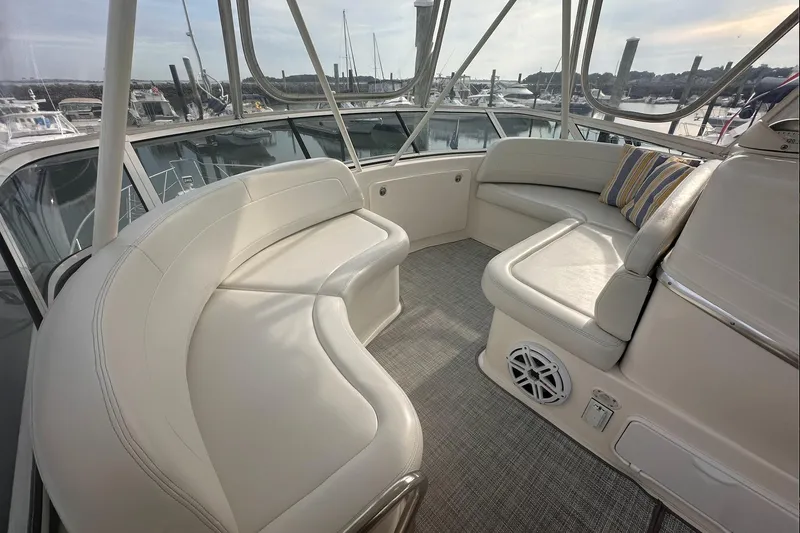 Slide: The Image of 2005 Silverton 42 Convertible yacht interior with white seating and striped pillow. - 13