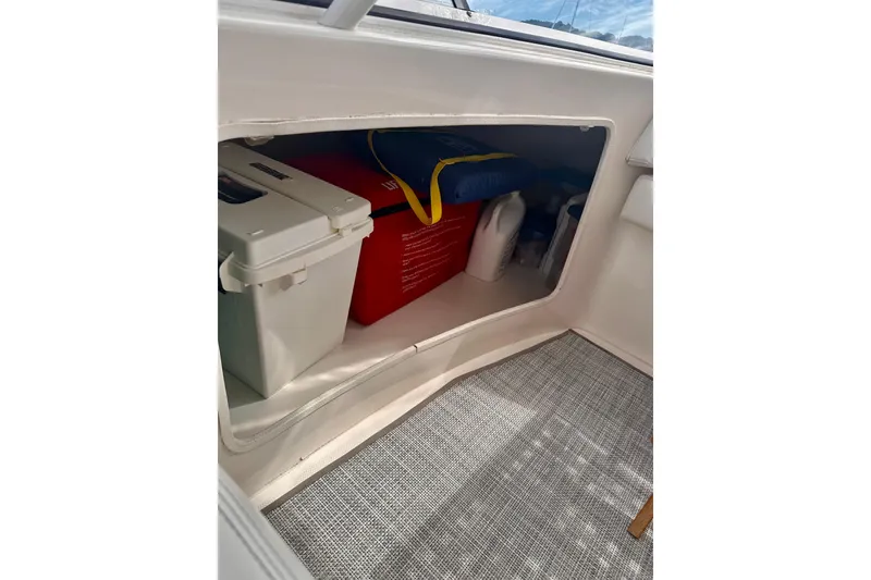 Slide: The Image of Storage compartment on 2005 Silverton 42 Convertible boat with cooler and supplies. - 14