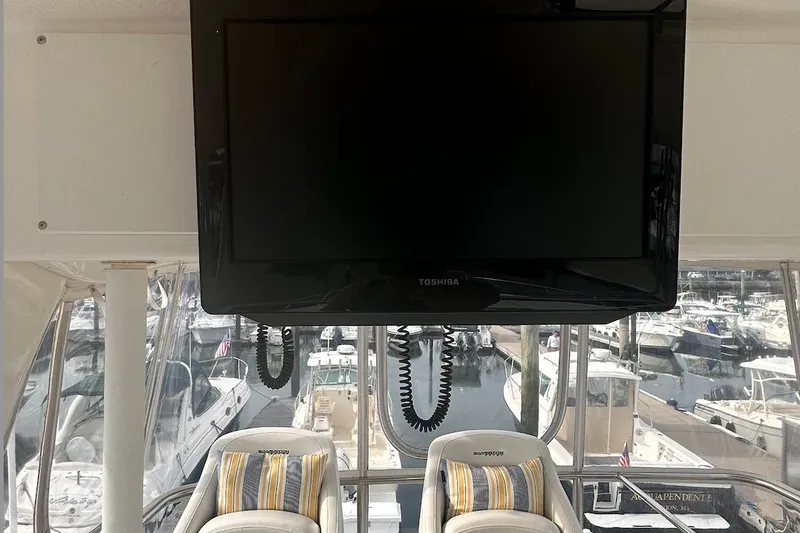 Slide: The Image of Interior of 2005 Silverton 42 Convertible yacht with TV and marina view. - 17