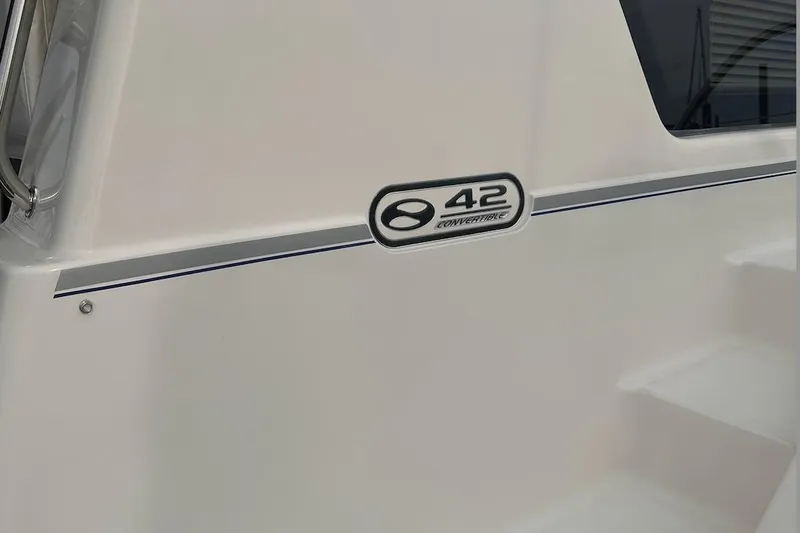 Slide: The Image of 2005 Silverton 42 Convertible yacht exterior with model emblem and sleek design. - 22