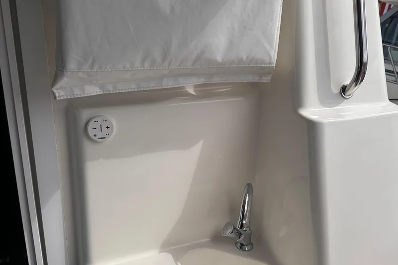 Slide: The Image of Interior detail of a 2005 Silverton 42 Convertible yacht, featuring a control panel and faucet. - 28