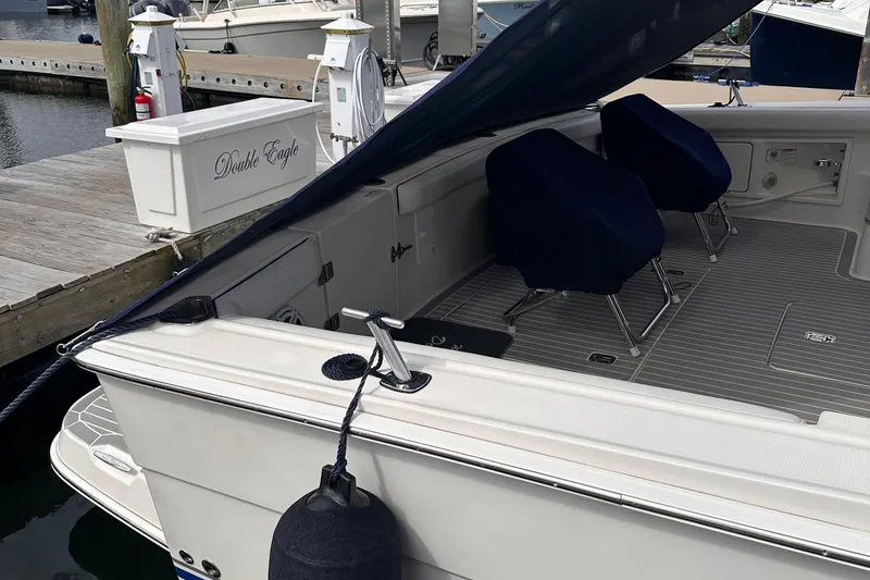 Slide: The Image of 2005 Silverton 42 Convertible yacht docked, featuring covered seating and nautical equipment. - 3