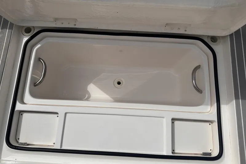 Slide: The Image of Open storage compartment on 2005 Silverton 42 Convertible boat, featuring metal handles. - 31