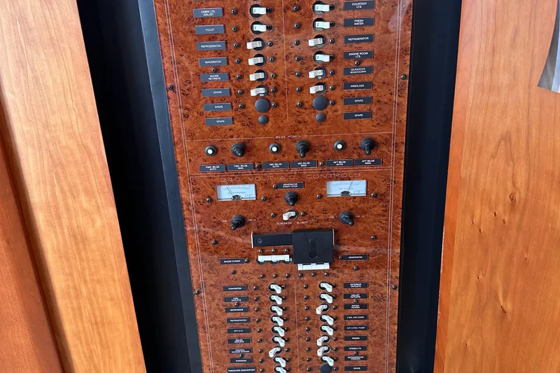 Slide: The Image of Control panel of a 2005 Silverton 42 Convertible yacht with various switches and dials. - 35