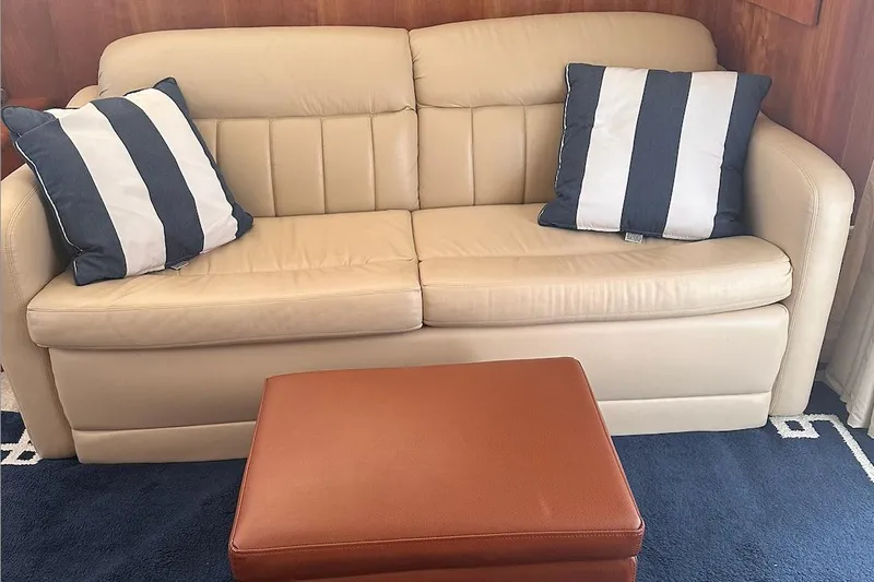 Slide: The Image of Beige leather sofa with striped cushions in 2005 Silverton 42 Convertible yacht interior. - 36