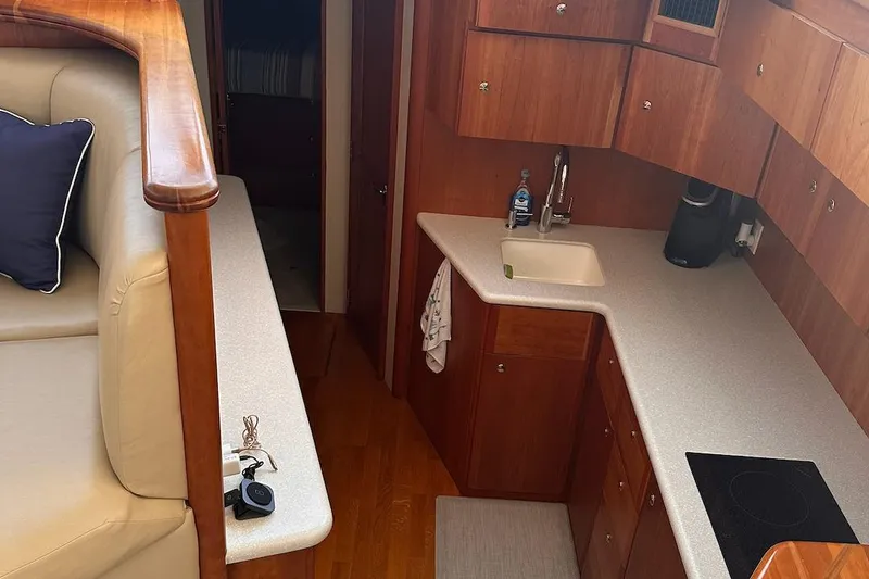 Slide: The Image of 2005 Silverton 42 Convertible yacht interior with kitchen and seating area. - 39