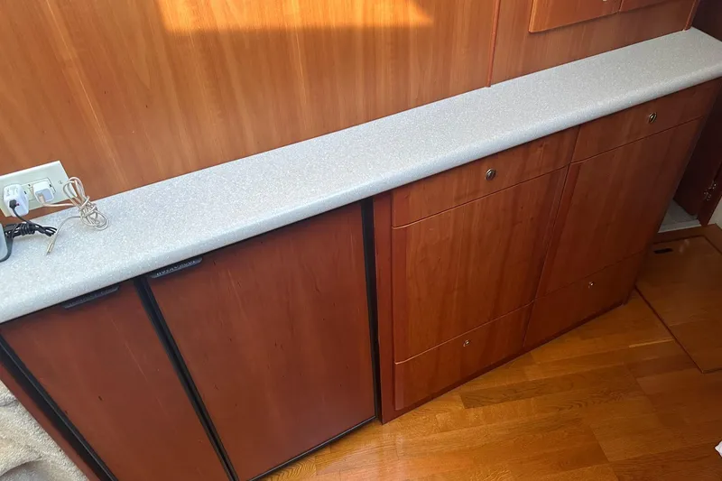 Slide: The Image of 2005 Silverton 42 Convertible yacht interior with wooden cabinets and countertop. - 41