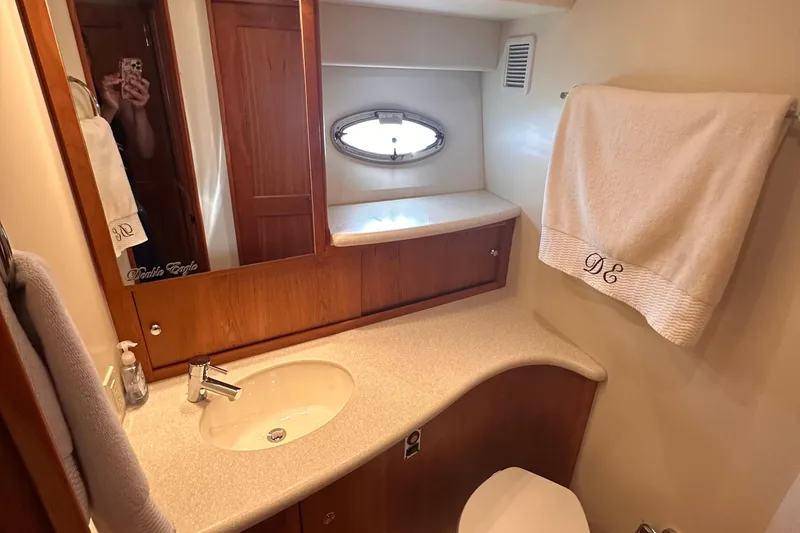 Slide: The Image of Luxurious bathroom in 2005 Silverton 42 Convertible yacht with elegant wood accents. - 44