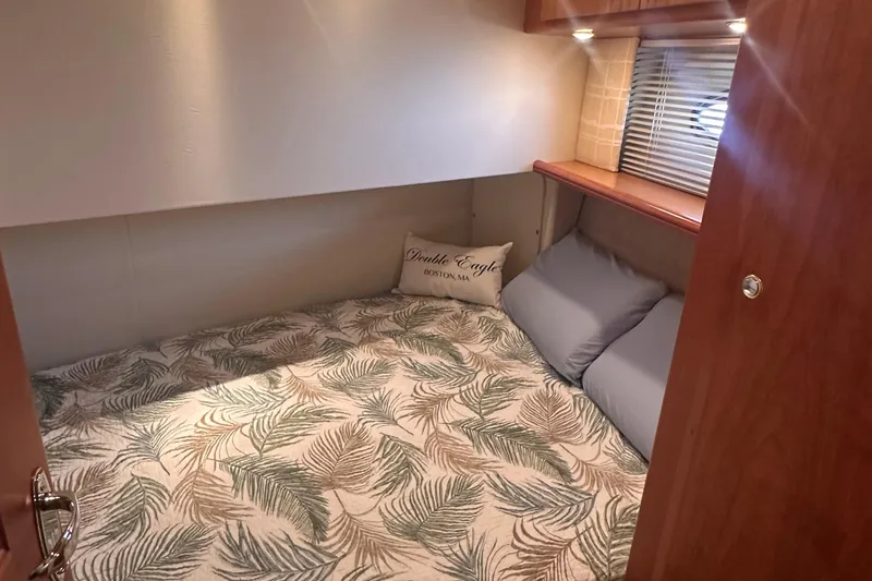 Slide: The Image of Cozy cabin interior of 2005 Silverton 42 Convertible yacht with leaf-patterned bedding. - 50