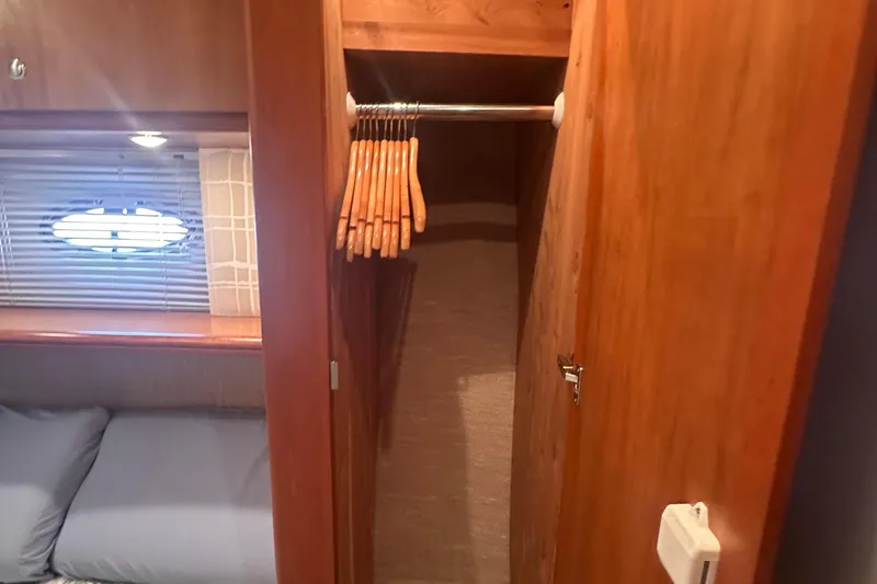 Slide: The Image of 2005 Silverton 42 Convertible yacht interior with closet and wooden hangers. - 51
