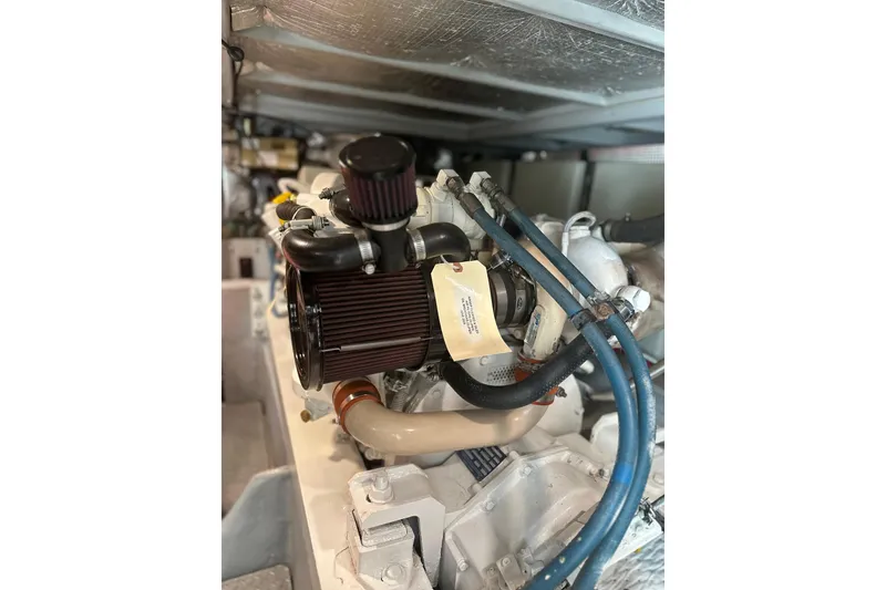 Slide: The Image of Engine compartment of a 2004 Silverton 42 Convertible boat, featuring hoses and components. - 56