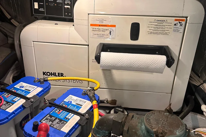 Slide: The Image of Engine room of 2004 Silverton 42 Convertible with Kohler power system and batteries. - 60