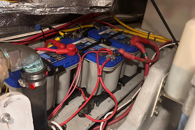 Slide: The Image of Battery compartment of a 2004 Silverton 42 Convertible boat with wiring and connections. - 63