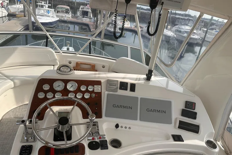 Slide: The Image of 2005 Silverton 42 Convertible yacht helm with Garmin navigation systems at marina. - 7
