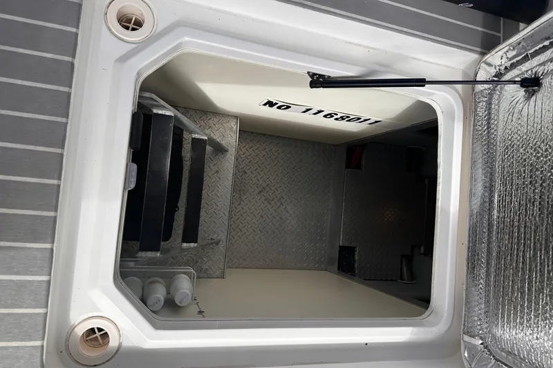 Slide: The Image of Hatch opening on a 2004 Silverton 42 Convertible boat, showing interior steps and storage. - 71