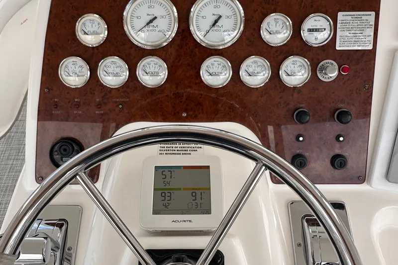 Slide: The Image of Dashboard of a 2005 Silverton 42 Convertible boat with gauges and controls. - 8