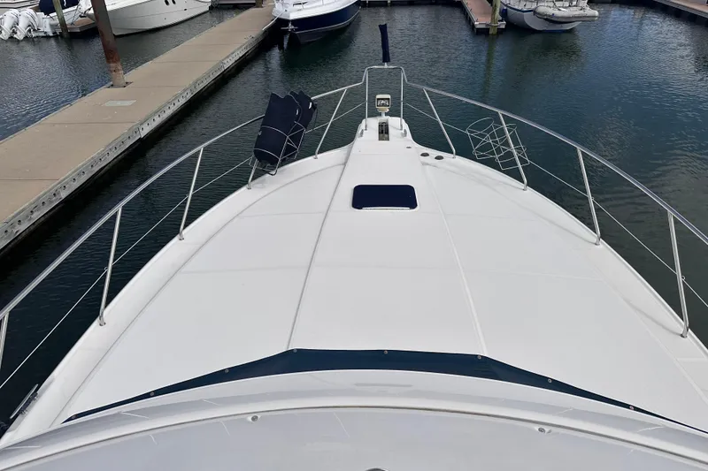 Slide: The Image of 2005 Silverton 42 Convertible yacht docked at marina, view from bow. - 9