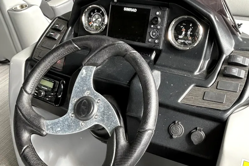 Slide: The Image of 2022 Veranda Relax VR22RC boat dashboard with steering wheel and control panel. - 8