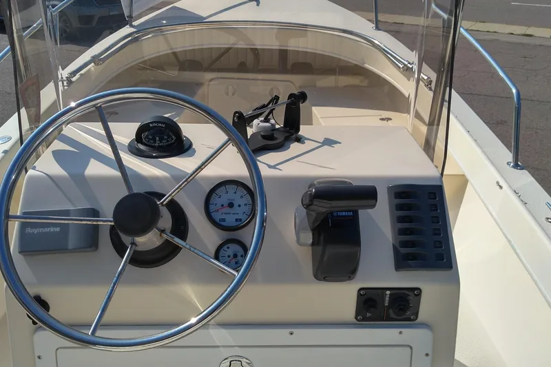 Slide: The Image of 2011 Eastern 20' Center Console boat dashboard with steering wheel and controls. - 3