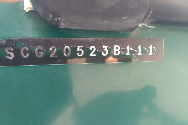 Slide: The Image of 2011 Eastern 20' Center Console boat hull identification number (HIN) on green surface. - 9