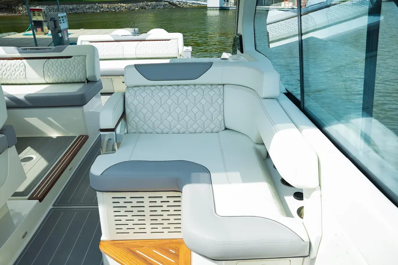 Slide: The Image of Luxurious seating on 2025 Regal LX43 boat, featuring elegant white and gray upholstery. - 10