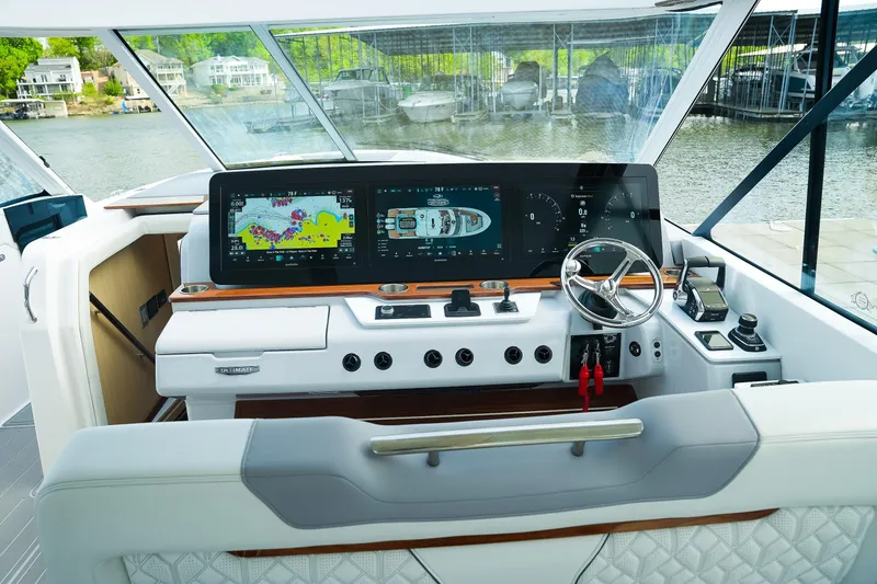 Slide: The Image of Helm of 2025 Regal LX43 boat with advanced navigation displays and controls. - 11