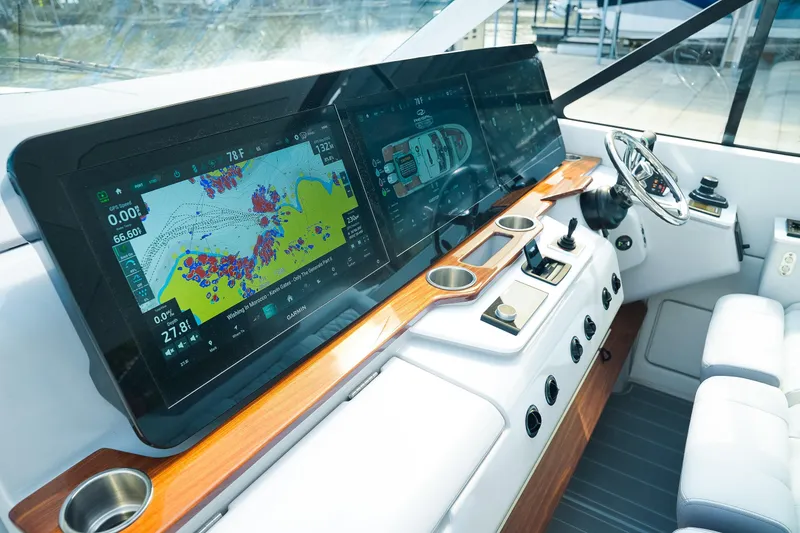 Slide: The Image of 2025 Regal LX43 boat dashboard with advanced navigation screens and controls. - 12