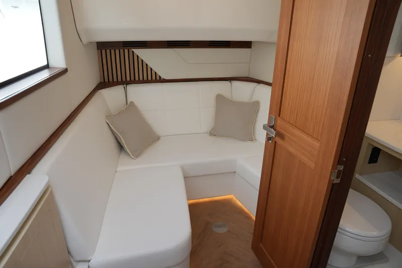 Slide: The Image of Luxurious interior of 2025 Regal LX43 yacht with cozy seating and elegant wood finishes. - 15
