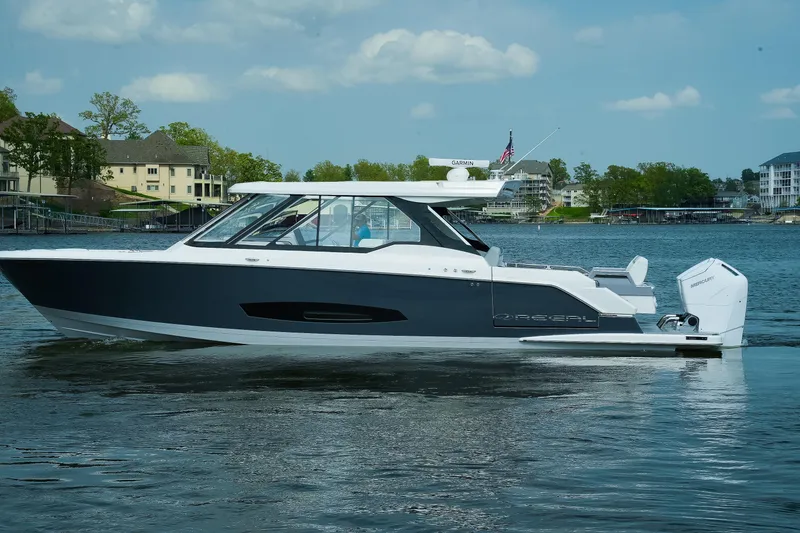 Slide: The Image of 2025 Regal LX43 boat on a serene lake with modern design and sleek features. - 19