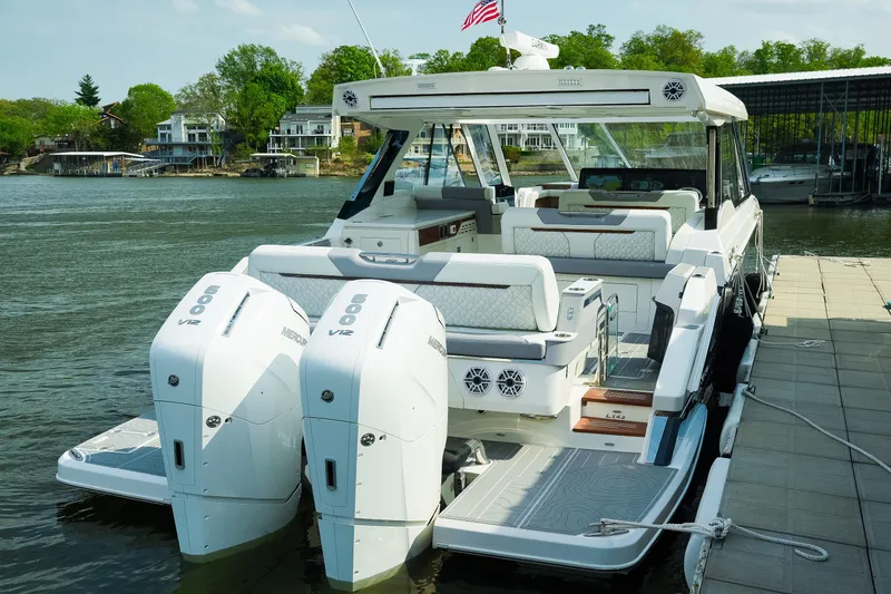 Slide: The Image of Luxury 2025 Regal LX43 boat docked, featuring dual Mercury V12 engines. - 4