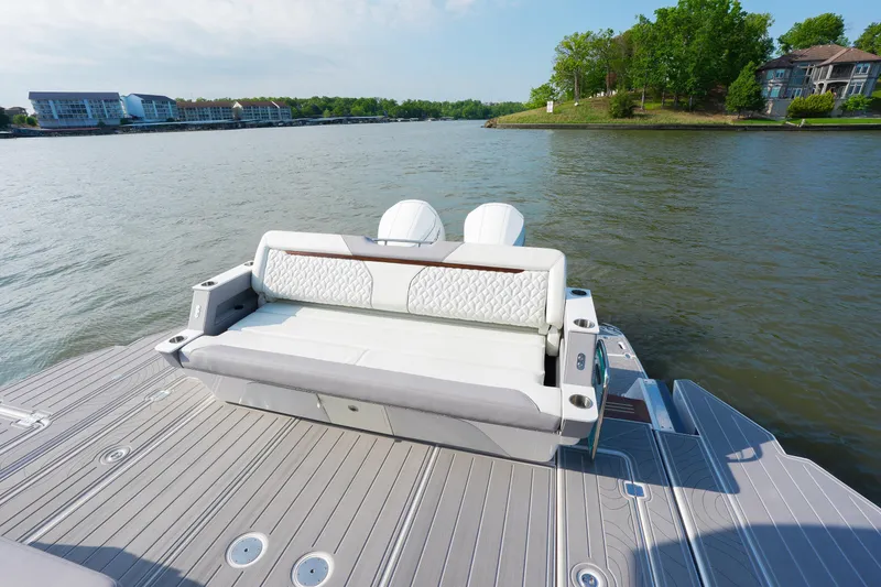Slide: The Image of 2025 Regal LX43 boat with luxurious seating on a serene lake. - 6