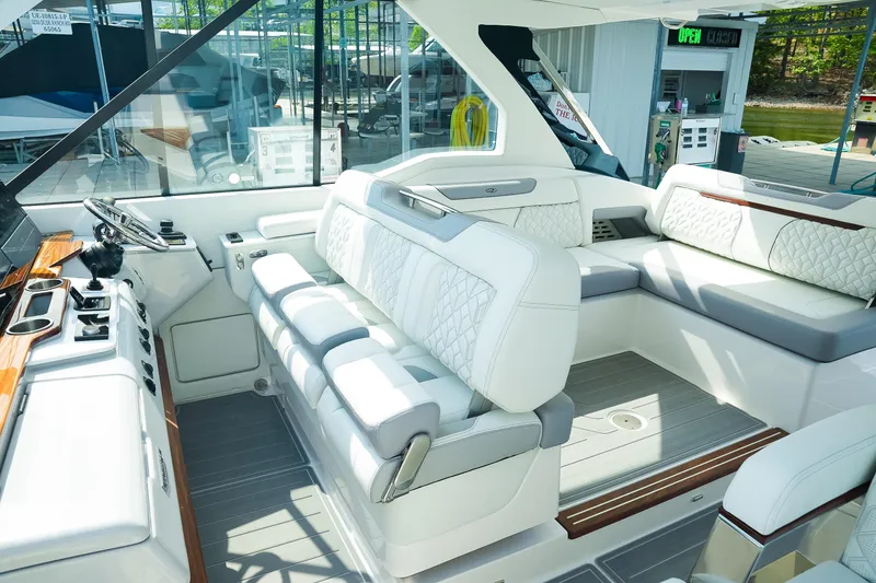 Slide: The Image of Luxurious interior of 2025 Regal LX43 boat with plush seating and modern controls. - 9