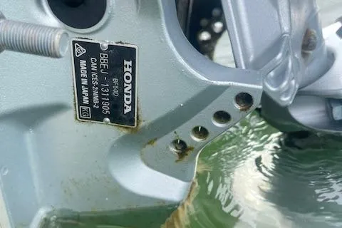 Slide: The Image of Close-up of a Honda motor on a 1964 Boston Whaler 17 Montauk boat. - 10