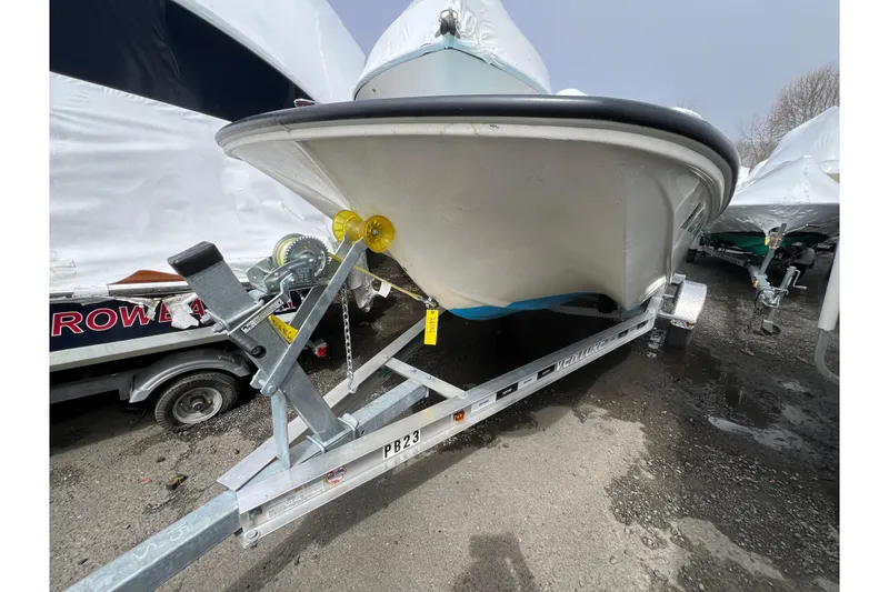 Slide: The Image of 1964 Boston Whaler 17 Montauk boat on trailer, parked outdoors. - 16