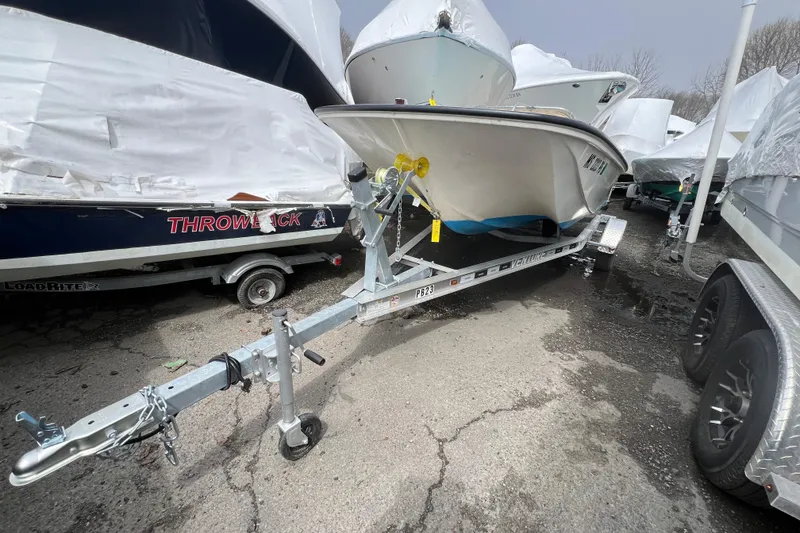 Slide: The Image of 1964 Boston Whaler 17 Montauk boat on trailer, parked outdoors. - 18