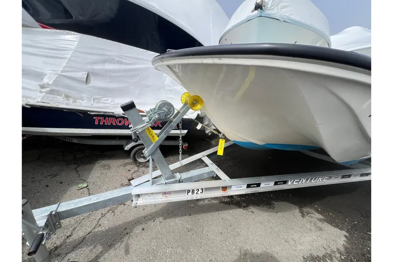 Slide: The Image of 1964 Boston Whaler 17 Montauk on trailer, parked outdoors. - 19