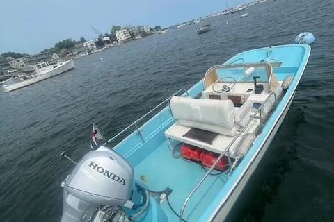 Slide: The Image of 1964 Boston Whaler 17 Montauk boat with Honda motor on calm water. - 7