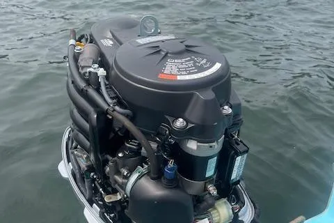 Slide: The Image of Outboard motor on a 1964 Boston Whaler 17 Montauk, floating on water. - 9