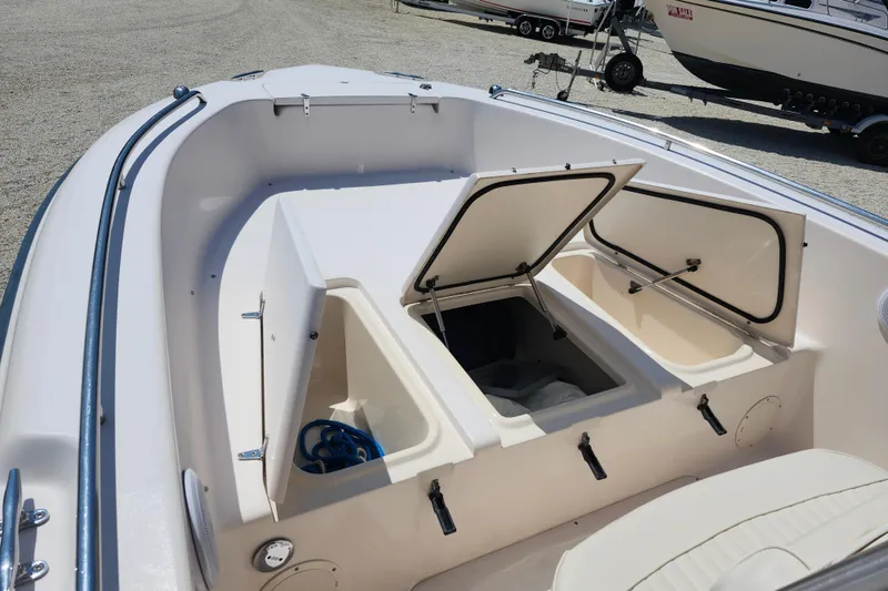 Slide: The Image of 2008 Grady-White Fisherman 222 boat with open storage compartments on deck. - 13