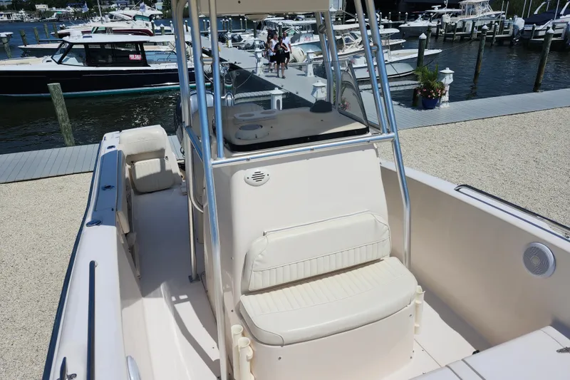 Slide: The Image of 2008 Grady-White Fisherman 222 boat interior at marina, showcasing seating and helm. - 16