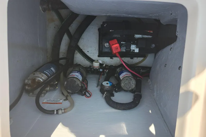 Slide: The Image of 2008 Grady-White Fisherman 222 boat compartment with battery and pumps. - 31
