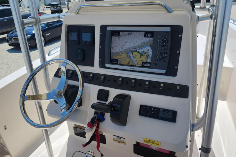 Slide: The Image of 2008 Grady-White Fisherman 222 boat dashboard with navigation system and steering wheel. - 6