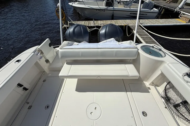 Slide: The Image of 2015 Robalo R305 Walkaround boat interior with seating and fishing equipment. - 10