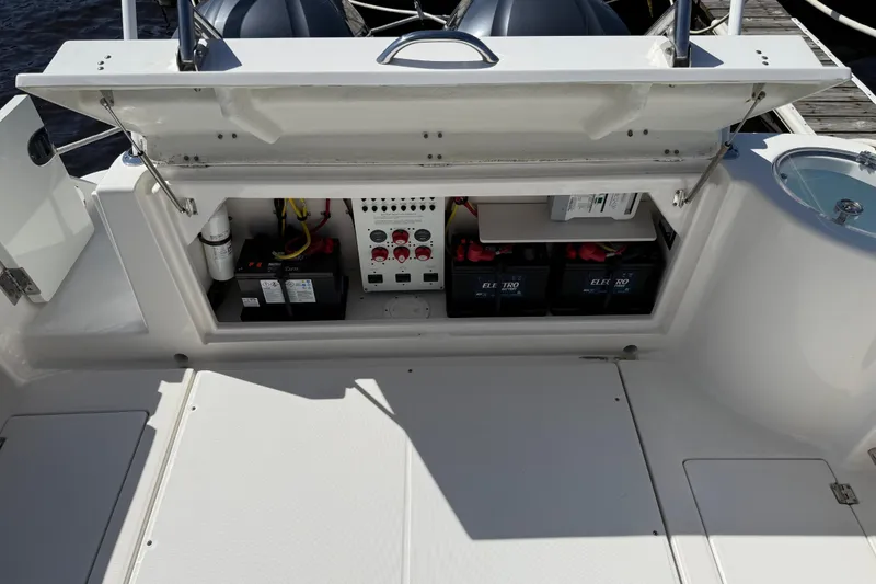 Slide: The Image of 2015 Robalo R305 Walkaround boat battery compartment with electrical panel and wiring. - 11